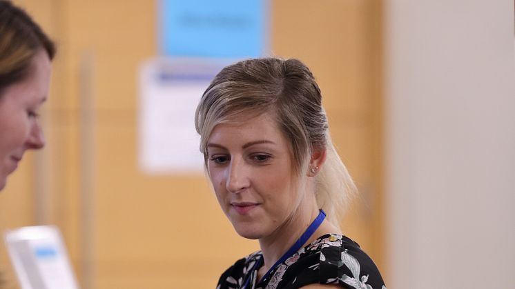 Woman using blood pressure monitor