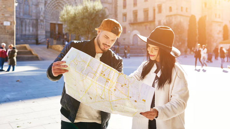 tourist in spain checking a city map