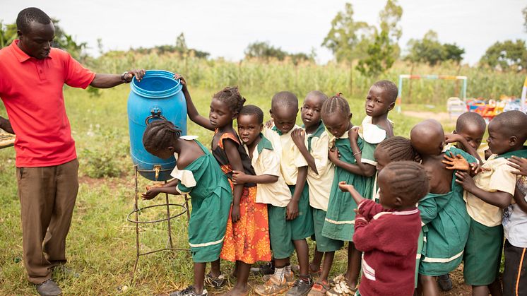 Barn på förskola i Uganda tvättar händerna. 