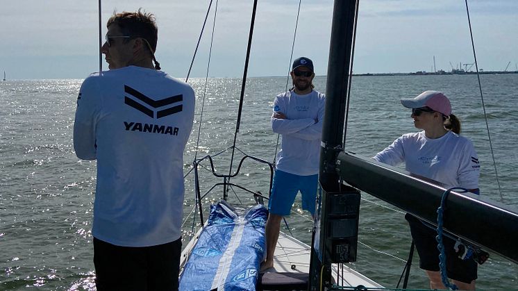 The Joyride sailing team sponsored by Yanmar America makes their way out to the race start.