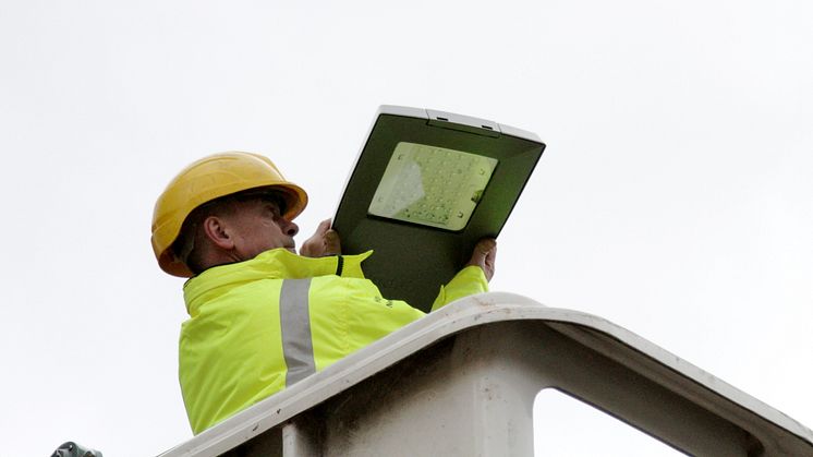 Street lighting supervisor Paul Birchall installs an LED light.