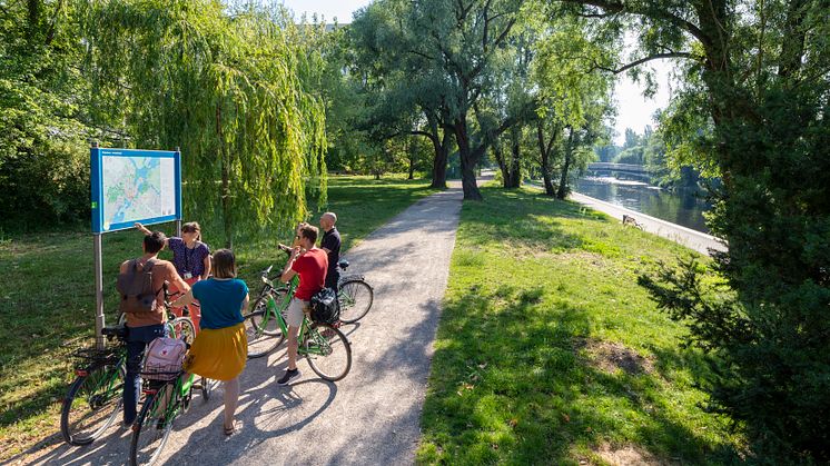 Ride a bike through the green of the city.