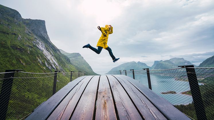 norway-senja-island-man-jumping-on-an-observatio-2022-11-06-22-48-24-utc (2)