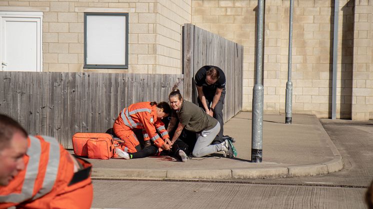 Student nurses supporting paramedics in a training exercise