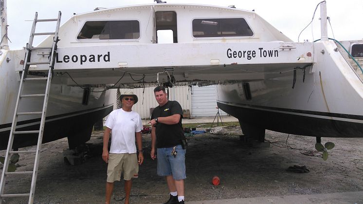 Charles Nethersole (left) with Capt. Cody Catapano, owner and captain of Sea Tow Crystal Coast, NC, and the recovered sailing catamaran Leopard. Photo: Sea Tow
