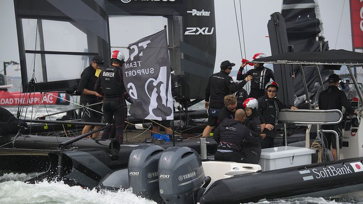 Support boats draw up to the yachts between races to provide supplies.