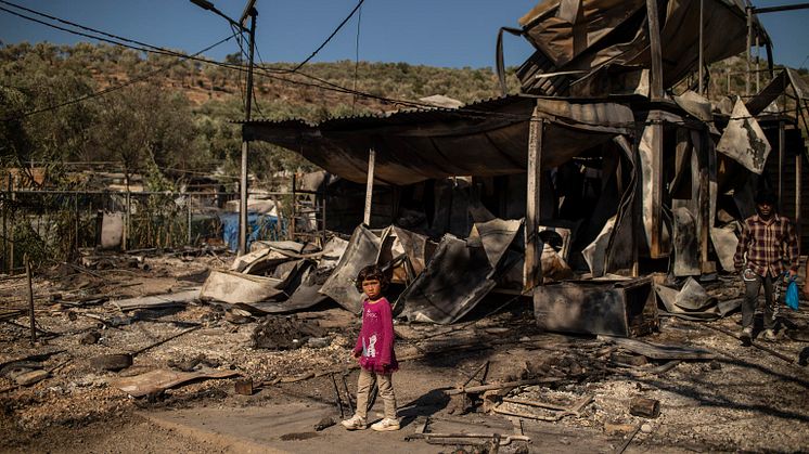 En flicka står i rasmassorna i det nedbrunna lägret Moria. Foto: © UNICEF/Tzortzinis/AFP