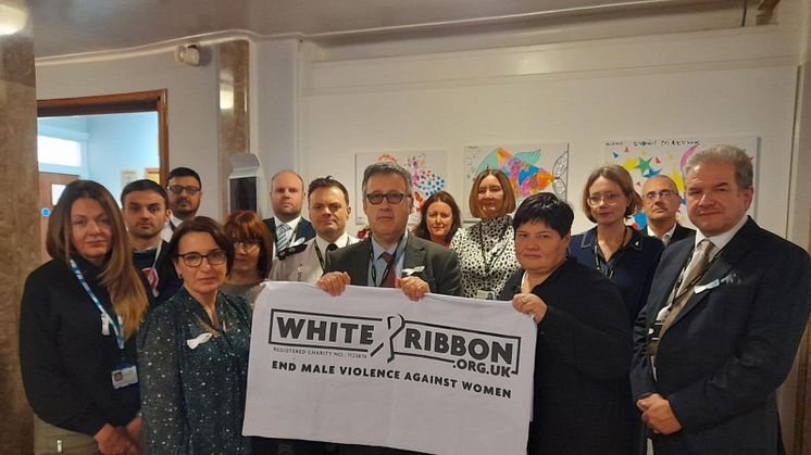 The Community Safety Partnership Board show their support for the White Ribbon campaign