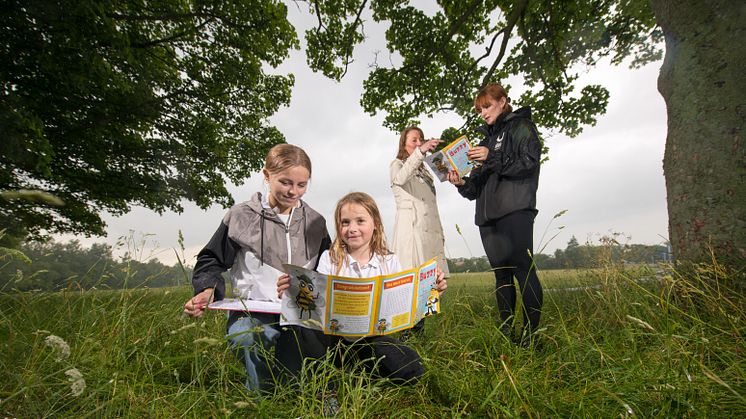 Left to right: Student Heledd Rimmer is pictured using the winning activity booklet with Catherine Burton (7), Senior Lecturer Rachael Chapman and Beelines Education Officer with Urban Green Newcastle, Rachel Faichnie.