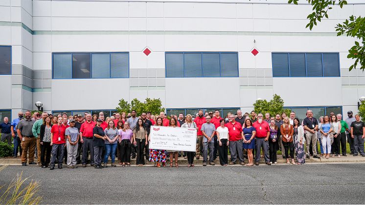 Yanmar America president Jeff Albright presents Rachel Castillo of Advocates for Children with the donation at a ceremony at Yanmar’s Adairsville Headquarters.
