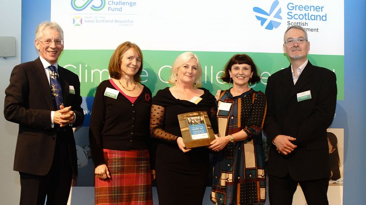 ng homes Regeneration Manager Margaret Fraser (Middle) receives the award from the Climate Challenge Fund Awards Panel.