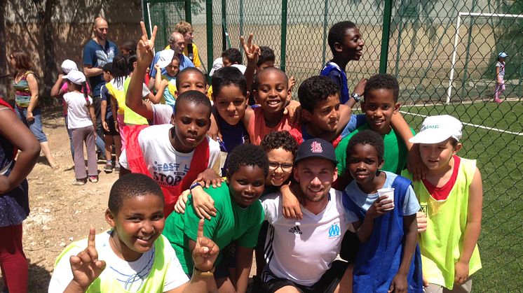 Marco with local children who will benefit from the new community football pitch.