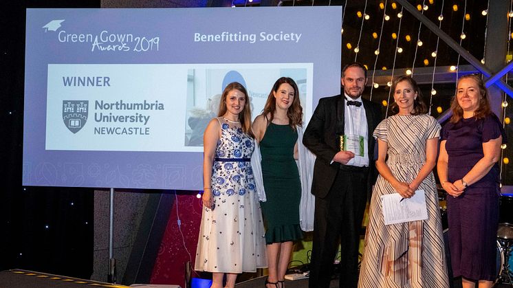 Northumbria's Rachel Dunn, Kayliegh Richardson, Paul McKeown, and Elizabeth Passey receiving the award from the Green Gown host