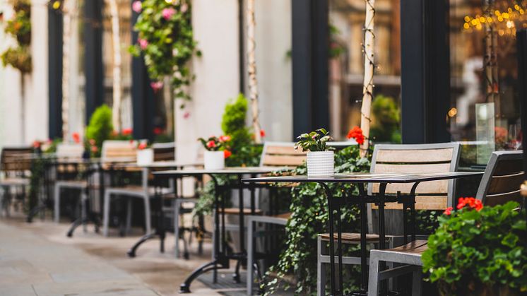 Bilden visar en restaurangs uteservering utsmyckad med blommor och växter (bild från Shutterstock)