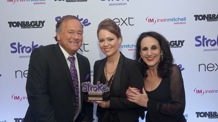 Lily Heinemann from Royal Mail receiving the award from Comedian and stroke survivor Duncan Norvelle and Actress Lesley Joseph.
