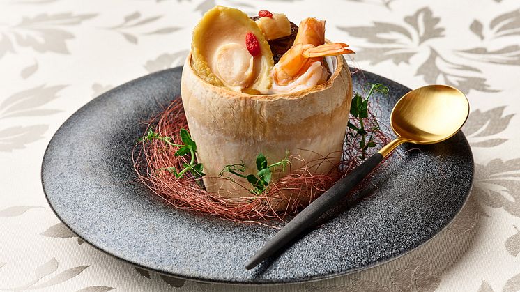 Double-boiled Chicken Soup with Abalone, Dried Scallops, Fresh Prawns and Chinese Mushrooms served in Young Coconut 