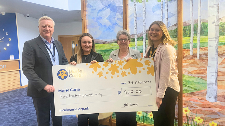Tony Sweeney (Director of Corporate Services, ng homes), Lucy Brown (Housing Assistant, ng homes), and Catherine Rossine (Chairperson, ng homes) present the cheque to Holly MacLean (Fundraising Assistant, Marie Curie).