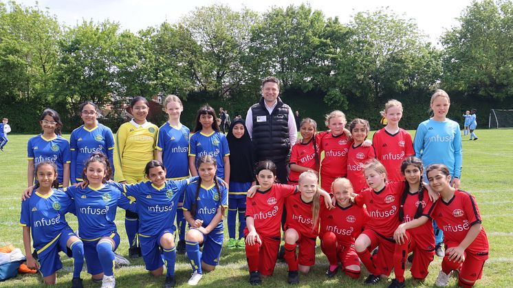 Pictured: Paul Howard, Managing Director at Infuse Technology, with Allenton and Pear Tree girls' football teams 