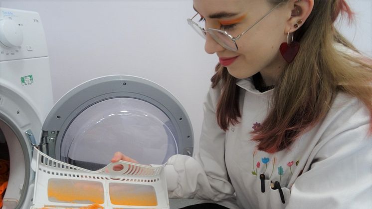 Student Amber Cummins examining microfibers collected on the dryer lint filter