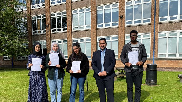 Celebration day – Cllr Tamoor Tariq meets students at his former school, The Derby High in Bury.
