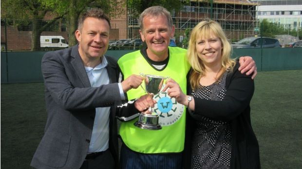 New Saints A Captain Trevor Whymark is pictured being presented with the 'Walking Football Cup' by Fred. Olsen Cruise Lines' Keith Norman, Business Development Manager, and Rachael Jackson, Public Relations Manager. 