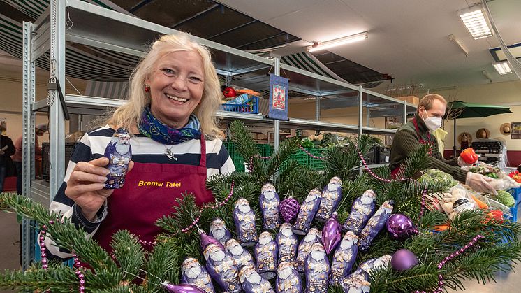 Eine Mitarbeiterin der Tafel in Bremen freut sich über die zarte Aufmerksamkeit von Mondelēz International und Milka.  Bildrechte: Mondelēz International.