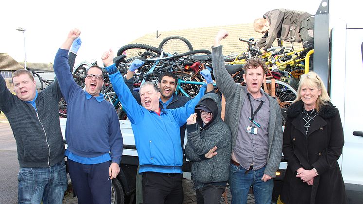 TAG Bikes Employment Skills Worker Robert Bierton (right) and members of the workshop take delivery of abandoned station bikes from GTR distribution manager Sarah Collett (far right)