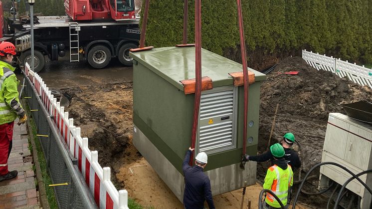 Die neue Ortsnetzstation Humsterdorf wird mit Hilfe eines Krans in Wewelsfleth aufgestellt.