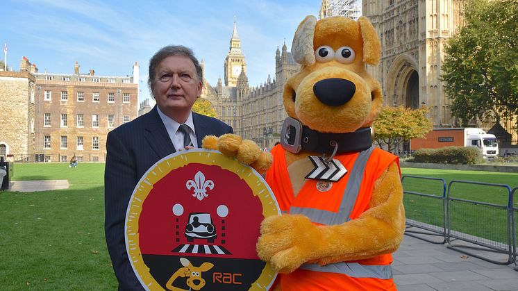 Horace and Sir Greg Knight holding Cubs Road Safety Awareness Champions badge
