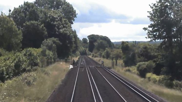 A still from the video that caught walkers crossing a railway line just metres in front of a Thamelink train
