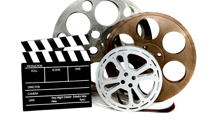 501055-movie-production-clapper-and-film-tins-on-white