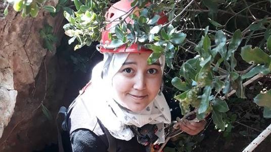 Visiting PhD student Baraa Rehamnia climbs down into one of the many underground caves in North Africa. Photographer: Hadjer Himrane