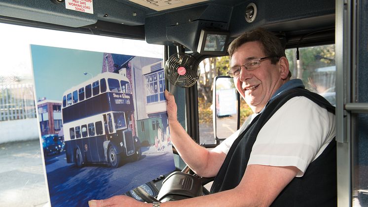 Andrew holding an image of the first bus he drove, at the start of his 43 year career on the buses.