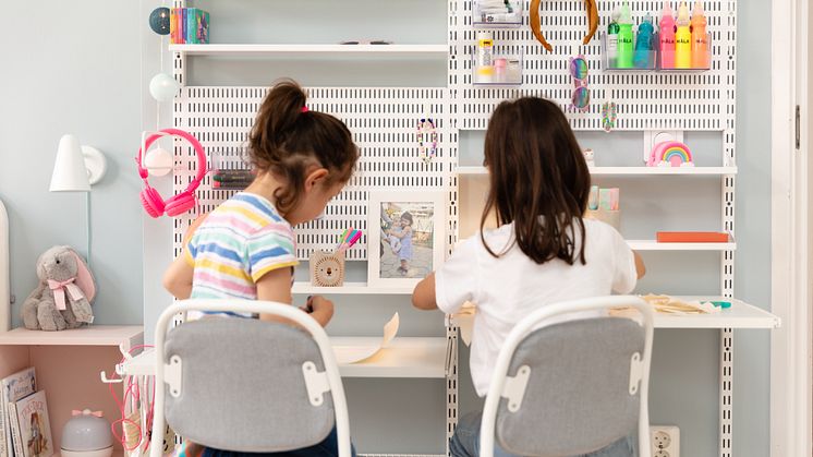 The wall-hung shelving offers a really practical solution as it can be easily adjusted to different heights so the girls can sit drawing, reading and being creative next to each other.