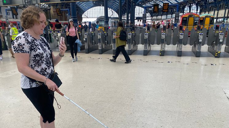 Linn Davies is guided through Brighton station using the Aira app