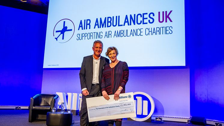 Jon Dye, Allianz's CEO presenting the cheque to Liz Campbell, Chairman of Air Ambulances UK