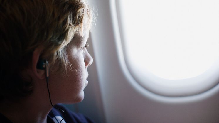 A child looking out his airplane window