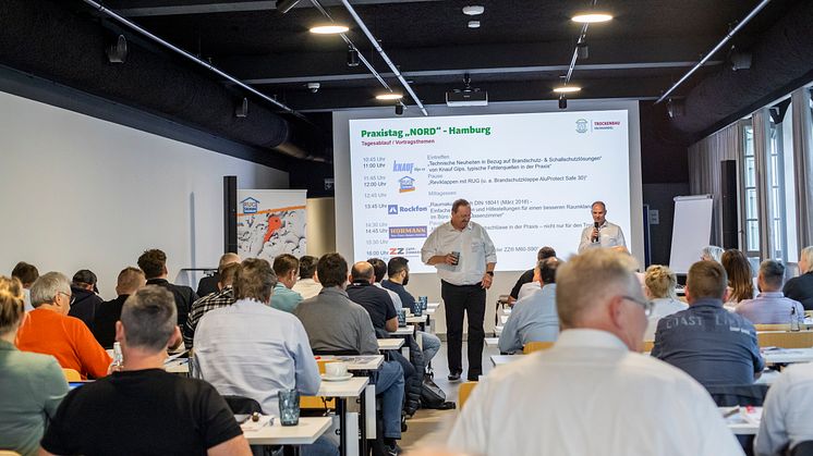 Jürgen Dieks (r.), Leiter Spezialisierungssystem Trockenbau, begrüßt die Teilnehmer der Praxistage Nord in Hamburg. Foto: hagebau (Abdruck honorarfrei)