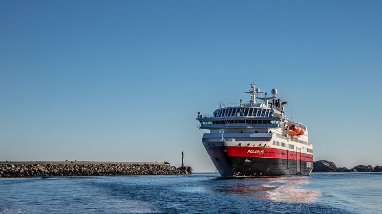 MS Polarlys passerer moloen og statuen Fiskarkona på vei til kai i Svolvær. Foto: Carsten Pedersen / Hurtigruten