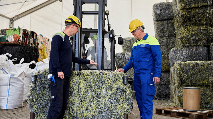 Rasmus Kærsgaard (left), Plant Director at Quantafuel and Dr. Michael Bachtler, who is working on BASF’s ChemCyclingTM project, in front of shredded mixed plastic waste which is turned into pyrolysis oil in Quantafuel's plant.