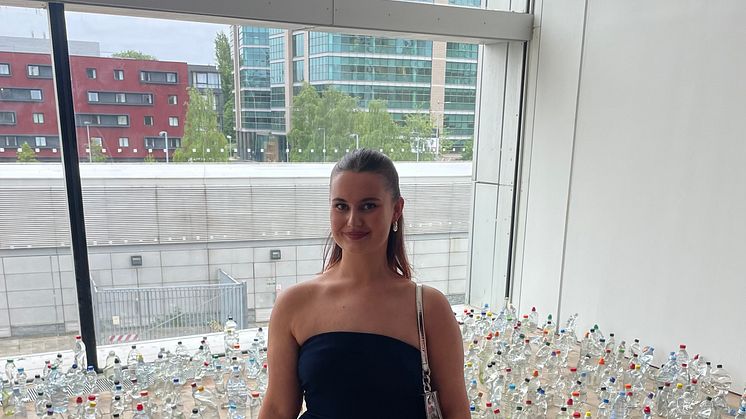 Northumbria University graduate Alice Kershaw is pictured with her work, Discarded Bottles.