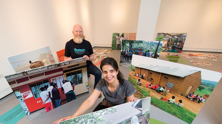 Professor Matt Baillie Smith and Dr Bianca Fadel help install the RYVU exhibition at Gallery North.