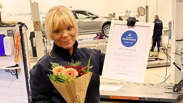 Anna Broberg som är besiktningstekniker på Bilprovningen i Värmdö-Mölnvik firas med diplom och blommor eftersom han utsetts till månadens medarbetare i företaget.