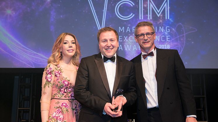 Stephen King (centre) collects his award from comedian and host Katherine Ryan and from sponsor Paul Carr, managing director of Stopgap