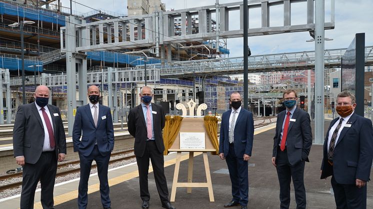 Thameslink and Great Northern MD Tom Moran (second from left) joins Network Rail's Route MD Rob Mackintosh and Rail Minister Chris Heaton-Harris (either side of the unveiled plaque) and other train company MDs at King's Cross on Monday