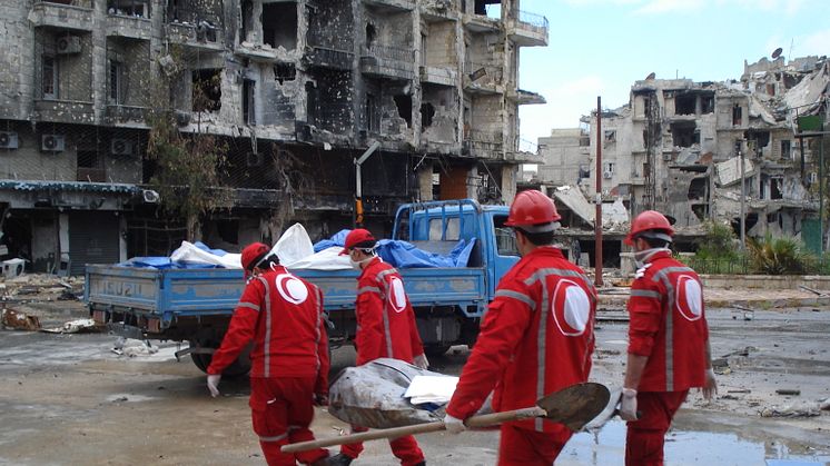 Syrian Arab Red Crescent volunteers retrieving bodies from the streets of Aleppo.