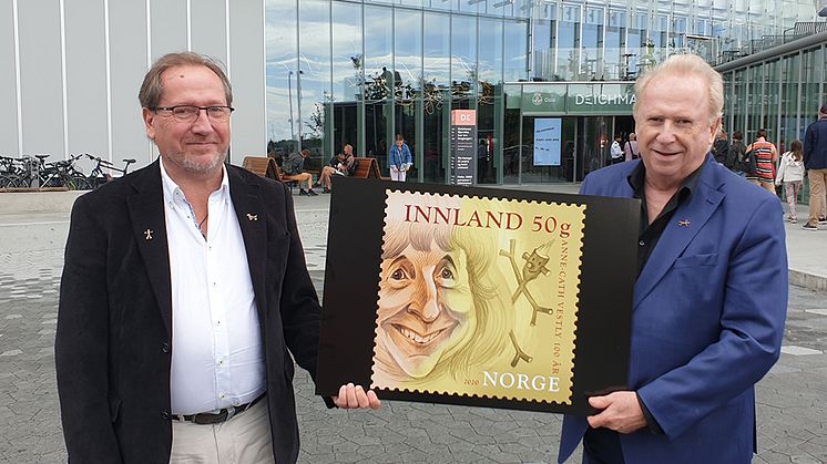 Jo (til høyre) og Håkon Vestly hadde et nært forhold til Knerten i oppveksten. Her viser de fram frimerket med moren. Det er tatt på Anne Cath Vestlys plass i Oslo, foran det nye Deichmanske bibliotek.