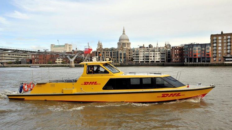 DHL Express riverboat on river with St Pauls.jpg