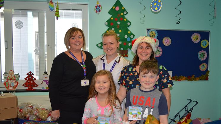 Jeanette Deboo and her daughter Kathryn presented the donations to Janine Standing, play specialist at East Surrey Hospital, and two young patients on the ward. 