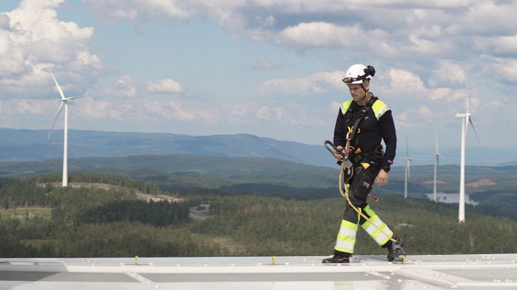 En ansatt fra Akershus Energi Vind på toppen av en turbin på Engerfjellet, Odal Vindkraftverk